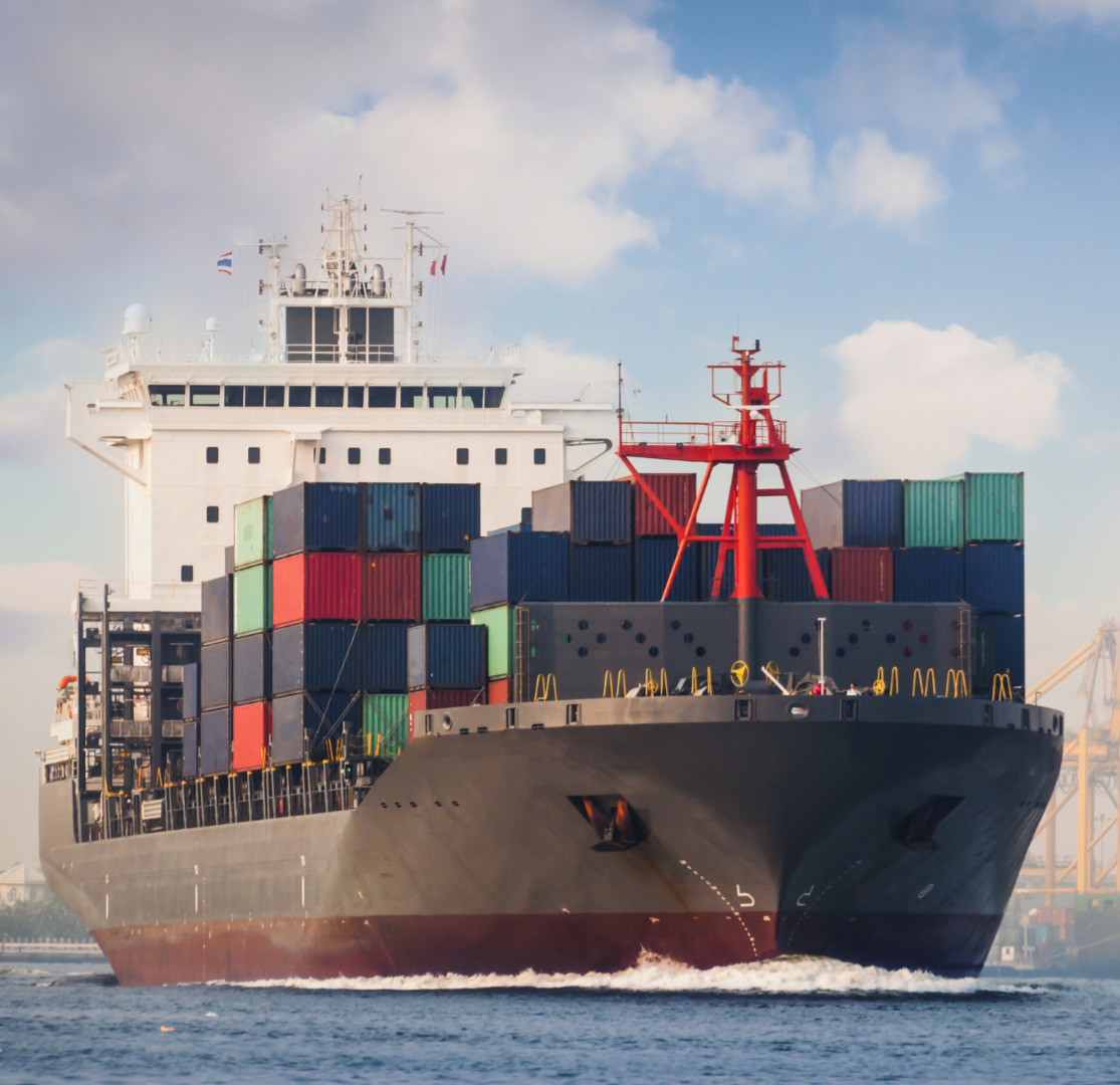 Container vessel docking at port with cranes