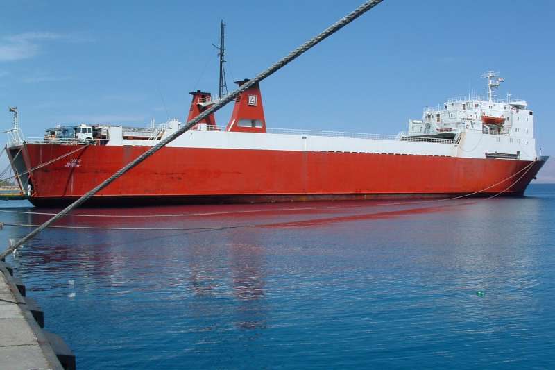MV Dodo - Red hull Ro-Ro vessel, photographed from port, clear reflection in water