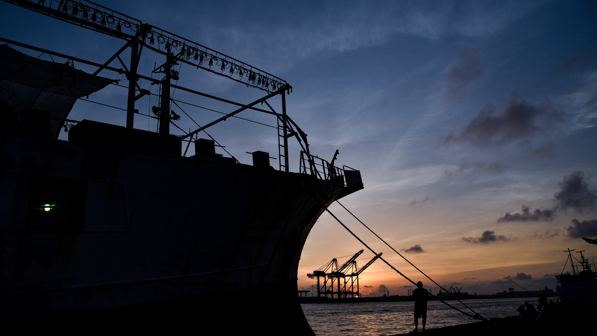 Silhouette of a port crane at sunset